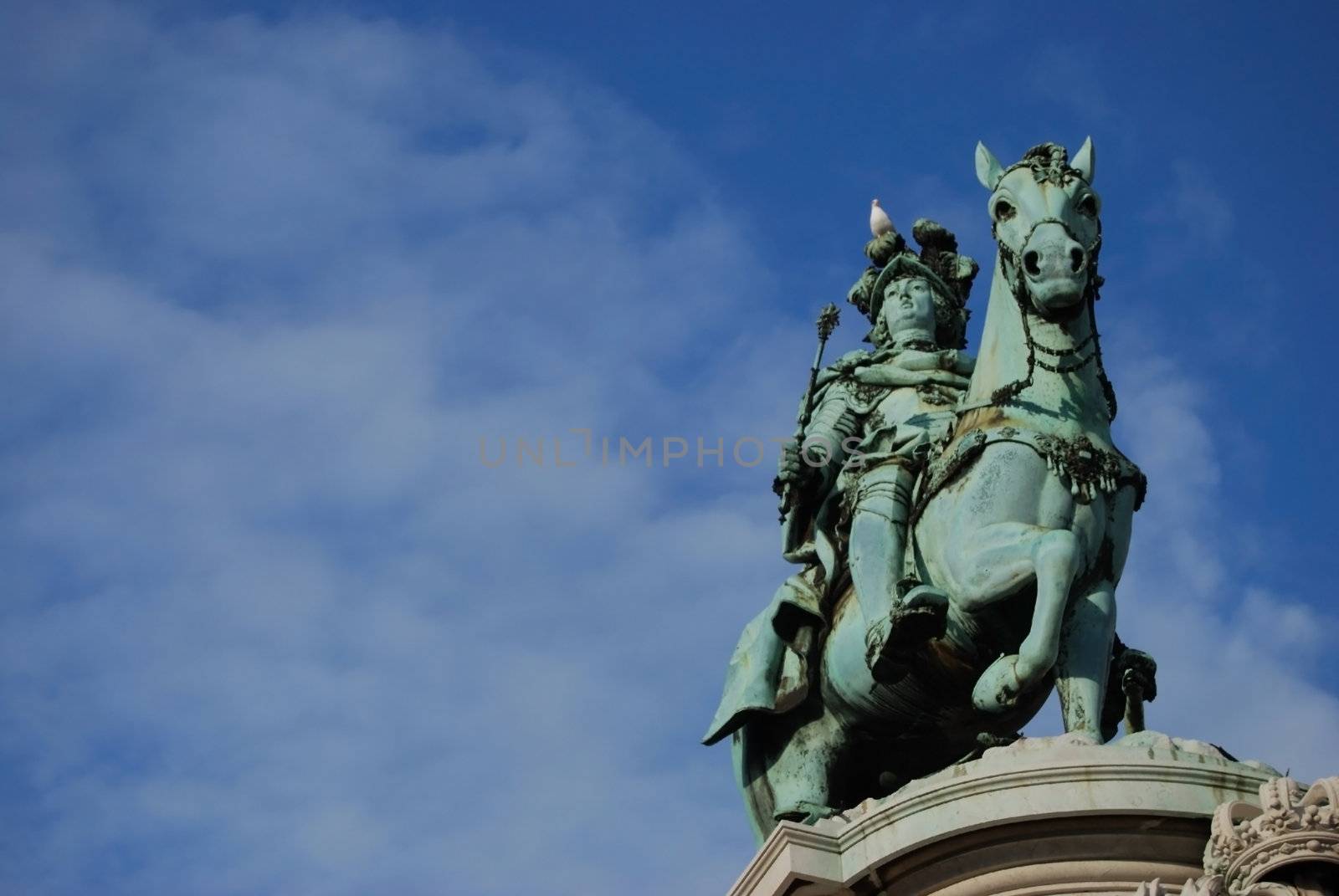 monument of the portuguese king Dom Jose I. at the Praca do Comercio in Lisbon, Portugal with a dove on his head