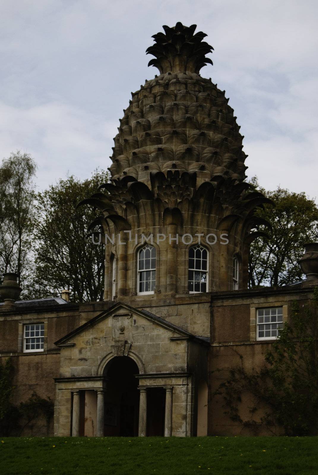 The Dunmore Pineapple is a remarkable folly situated in Dunmore Park, approximately one kilometre northwest of Airth in the Falkirk council area, Scotland. One of the architectural wonders of Scotland, the building was built in the grounds of Dunmore House as a garden retreat and hothouse in 1761 by John Murray, 4th Earl of Dunmore. After the discovery of pineapples by Christopher Columbus on the Caribbean island of Guadeloupe in 1493, the pineapple became a rare delicacy in Europe, and was symbolic of power, wealth, and hospitality. The pineapple was adopted as a motif by architects, artisans and craftsmen, being sculpted into gateposts, railings, weather vanes and door lintels. The Dunmore Pineapple is perhaps the most spectacular architectural use of the motif. 