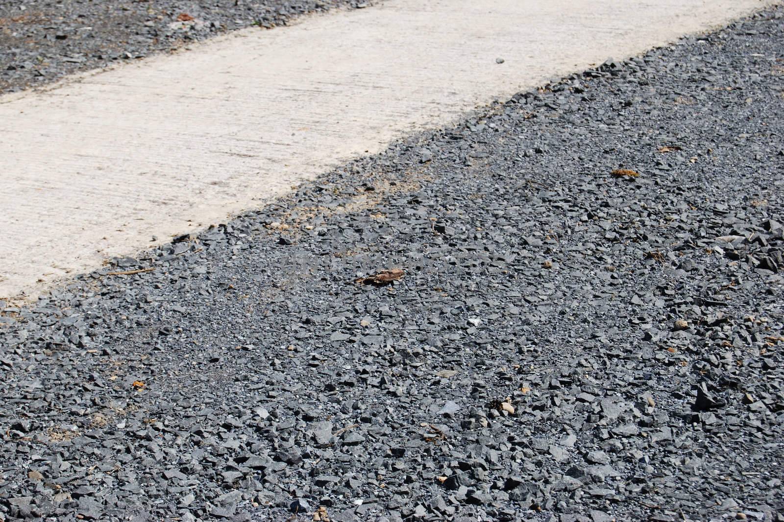 geometrical looking patch of pebbles with a white path crossing