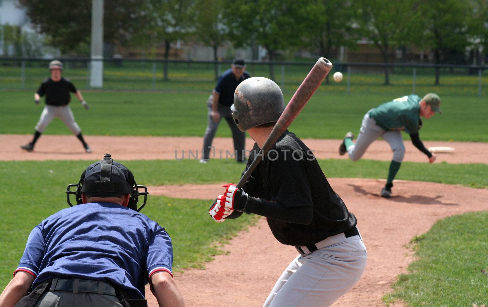 The pitcher has just released the ball, the batter is about to swing.