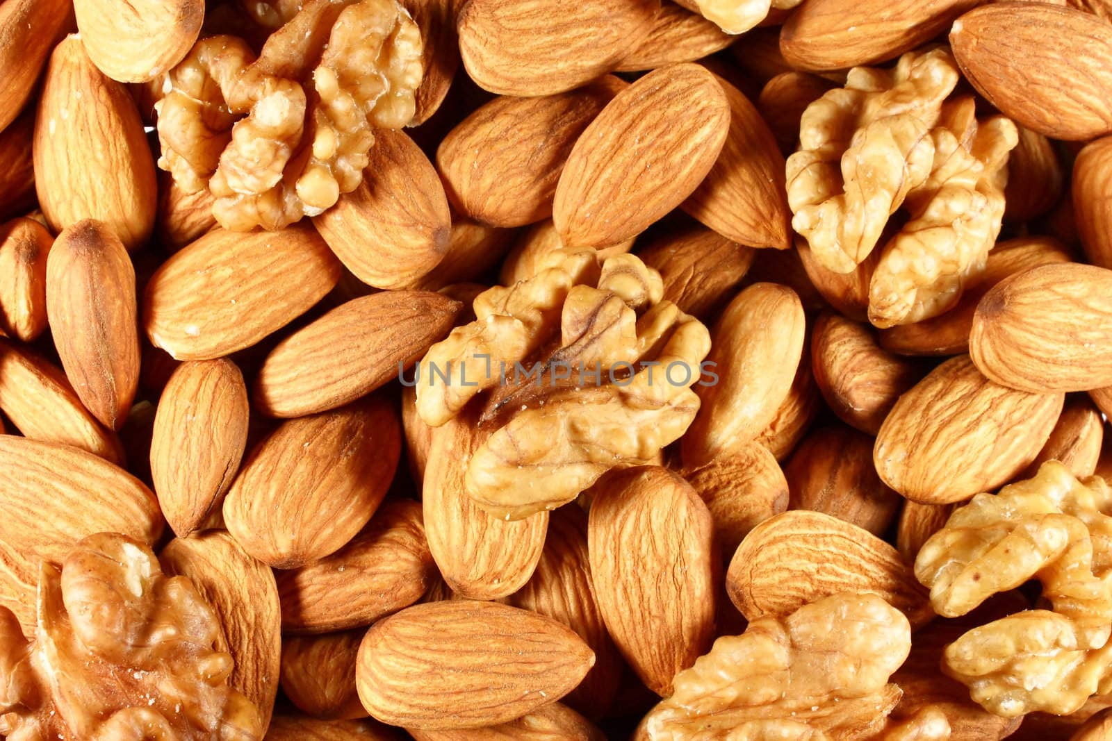 pile of almond nuts and walnuts as background