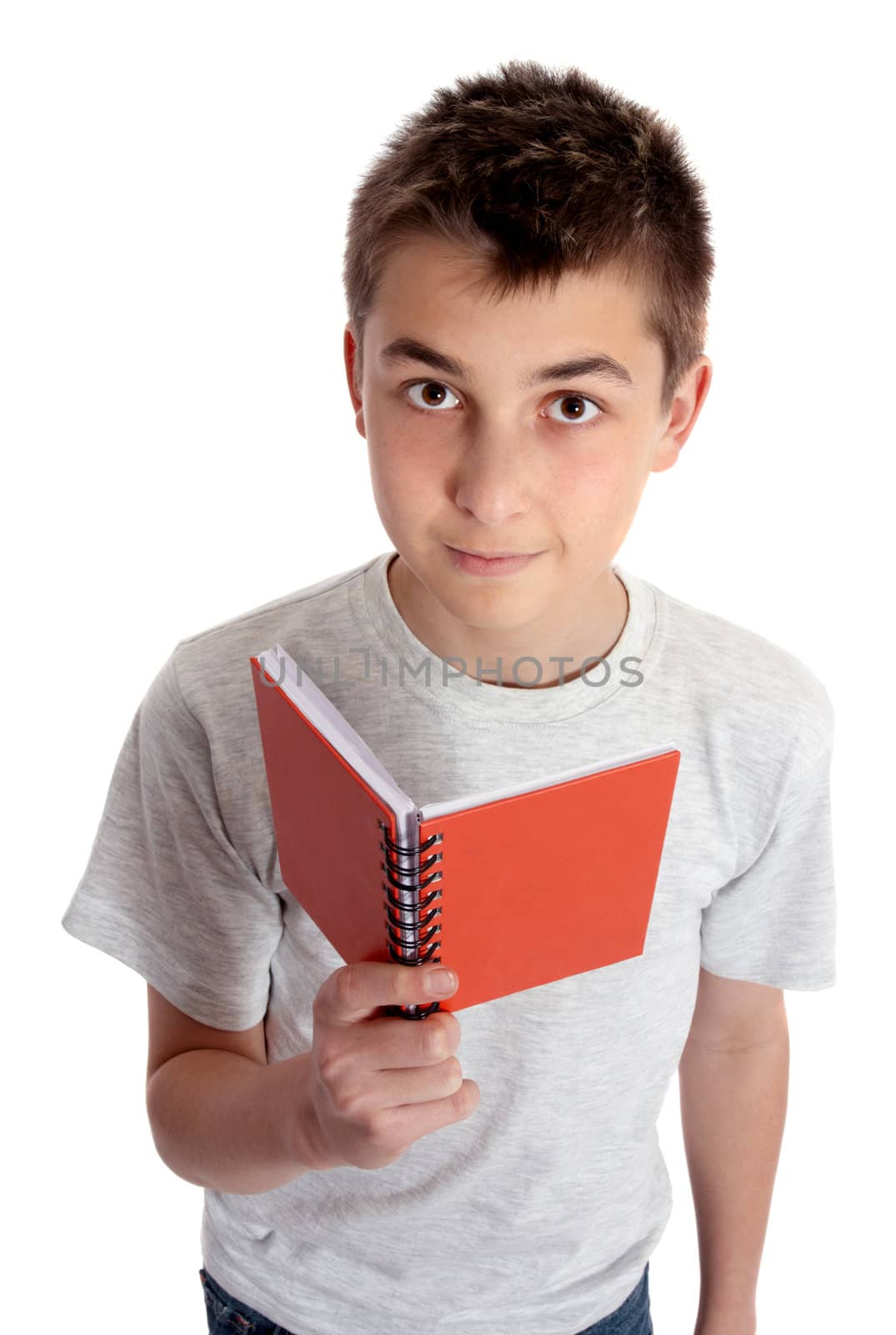 Child holding a red book and looking up.