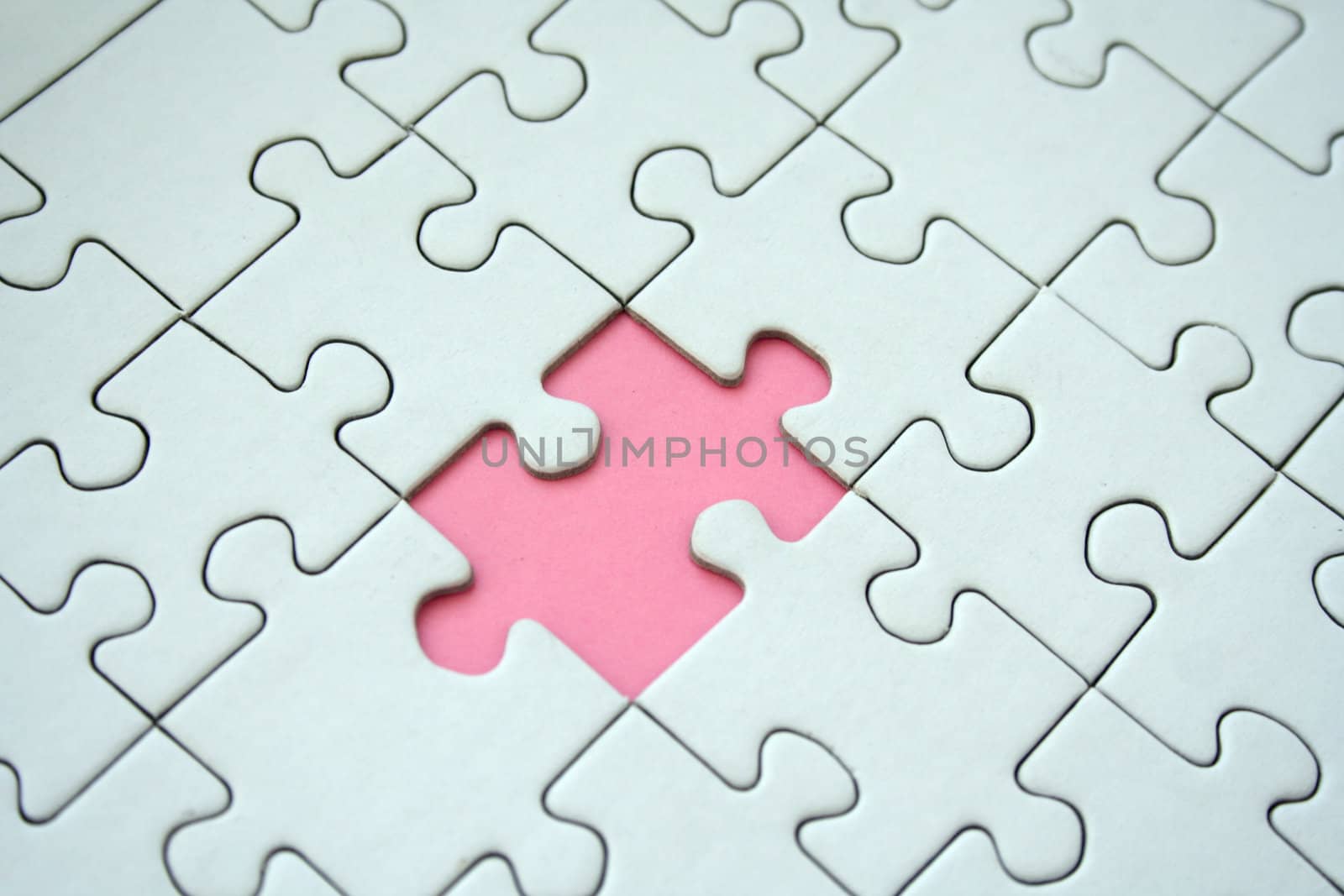 White jigsaw pattern with one empty pink element