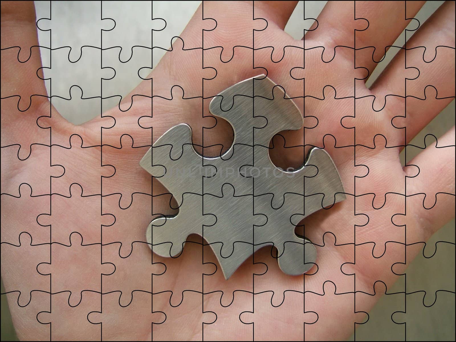 Metallic jigsaw piece in man hand with jigsaw pattern