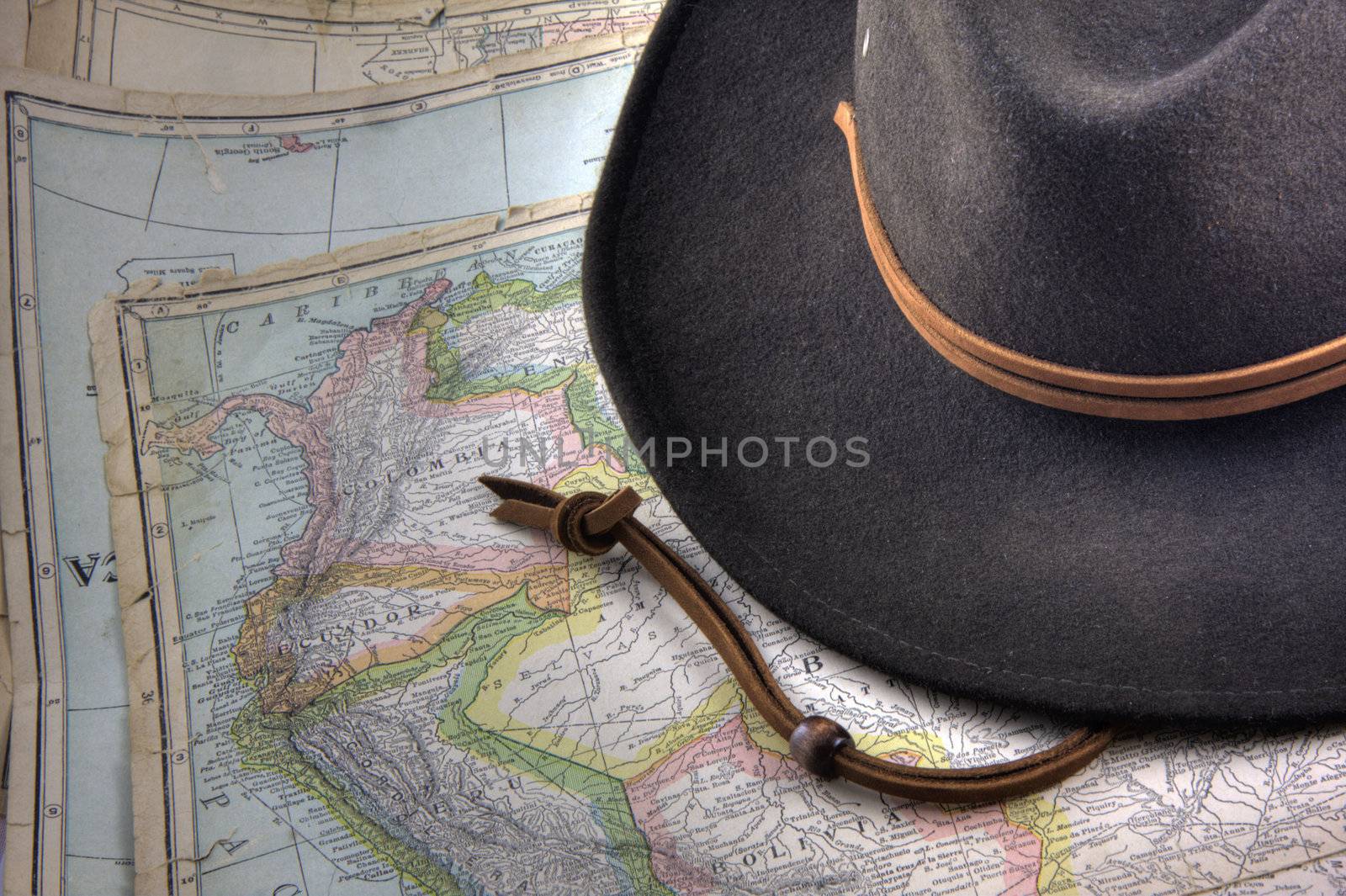 felt hat over a vintage, warn out map of South America (New International Atlas of the World, 1926 edition) with Peru, Ecuador, Colombia, Bolivia and Venezuela