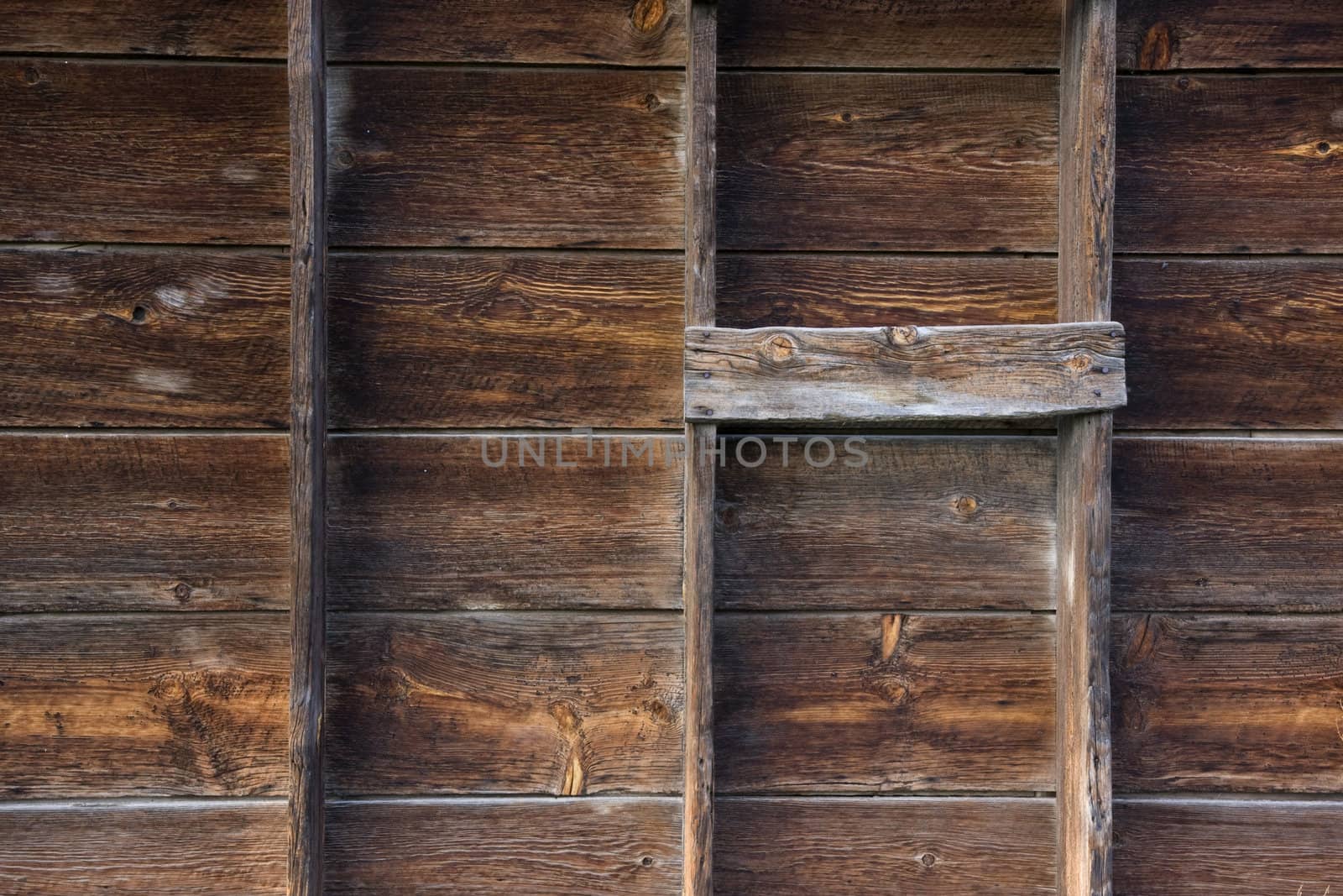 old barn wall with verical posts - weathered wood background with grid pattern