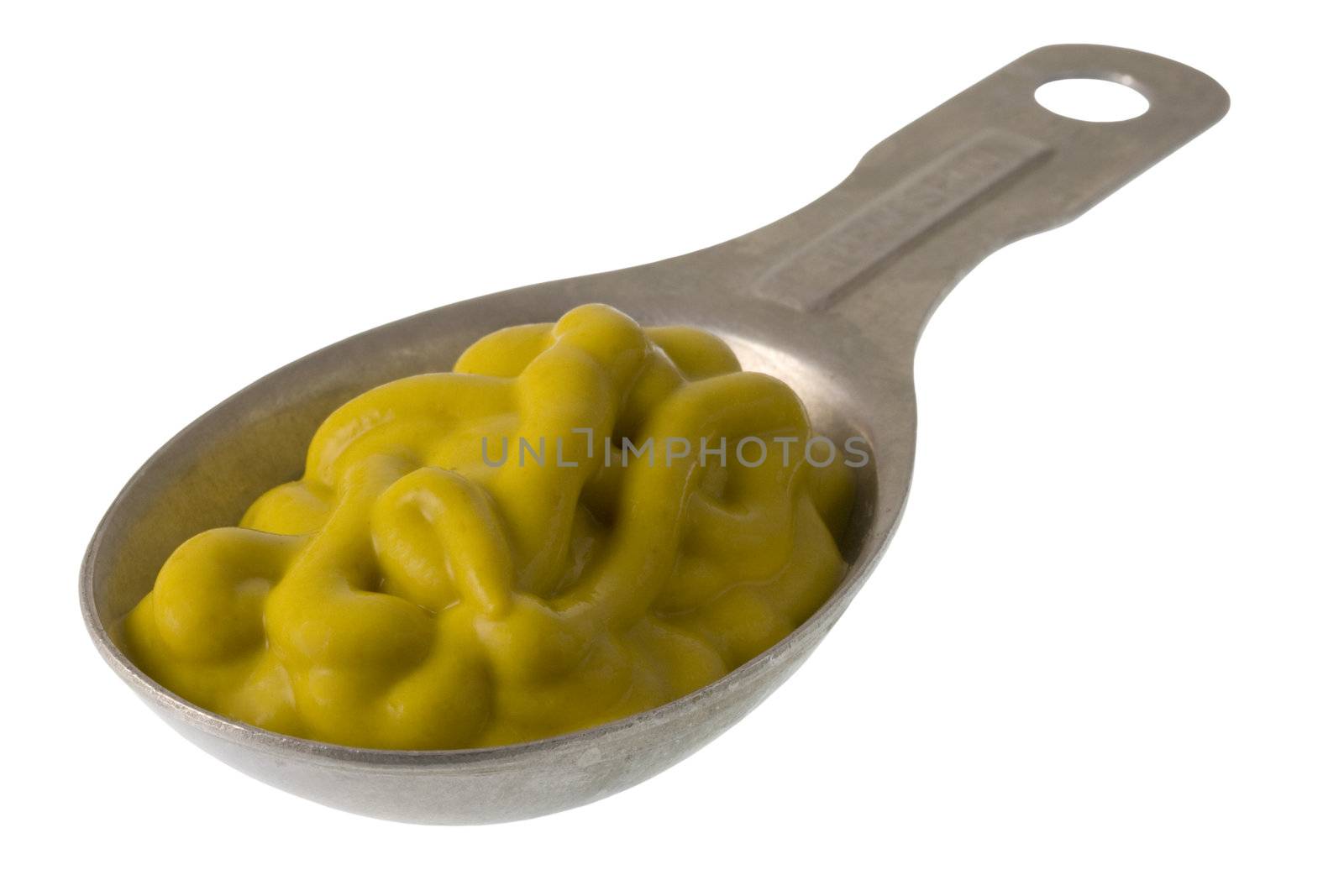 aluminum measuring tablespoon of yellow mustard isolated on white