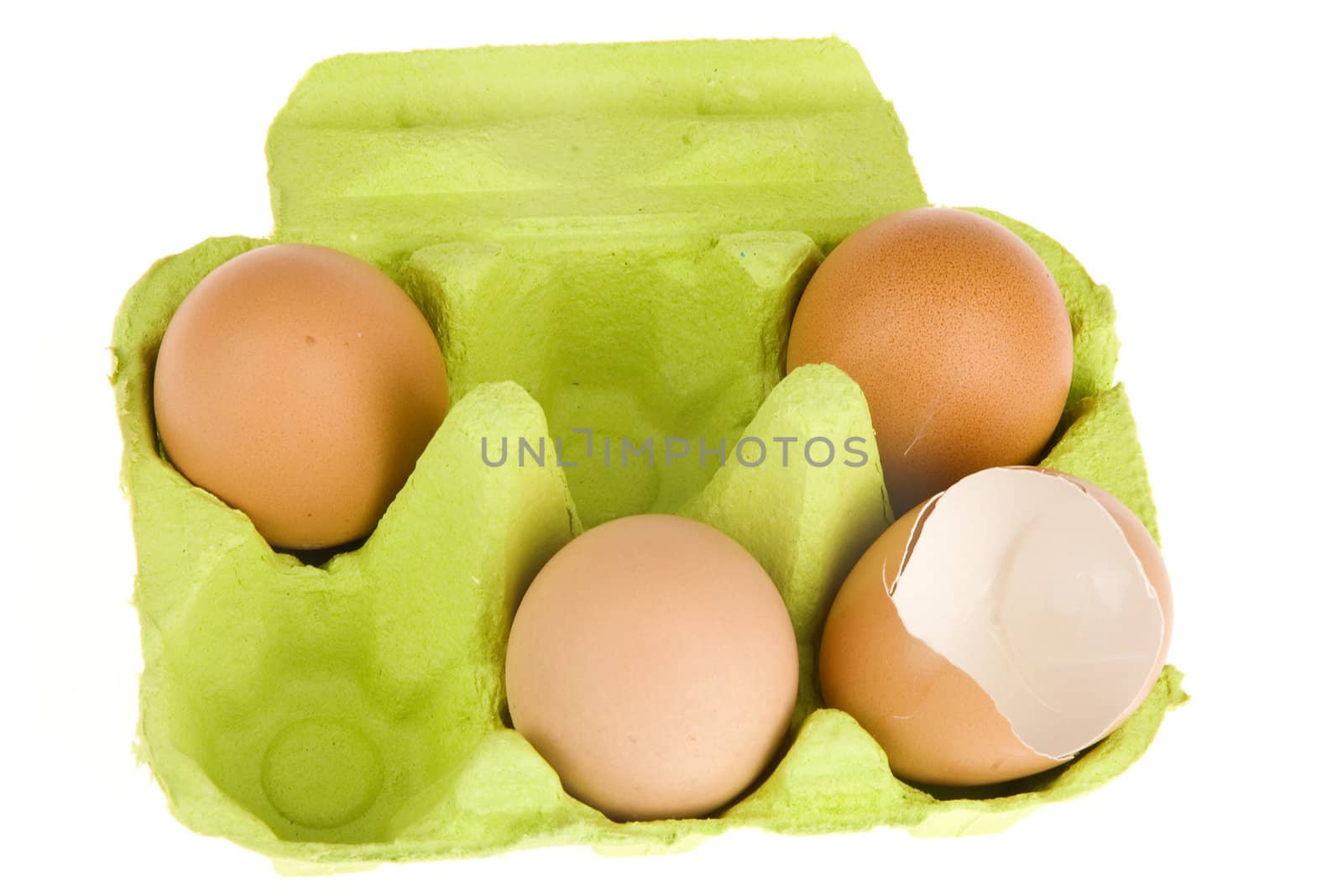 three eggs in a green box and egg shells