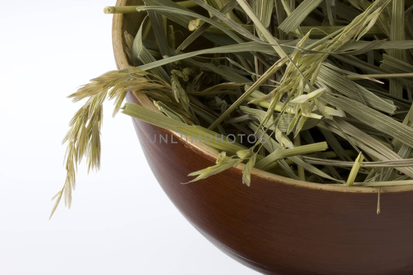grass hay in a wooden bowl by PixelsAway