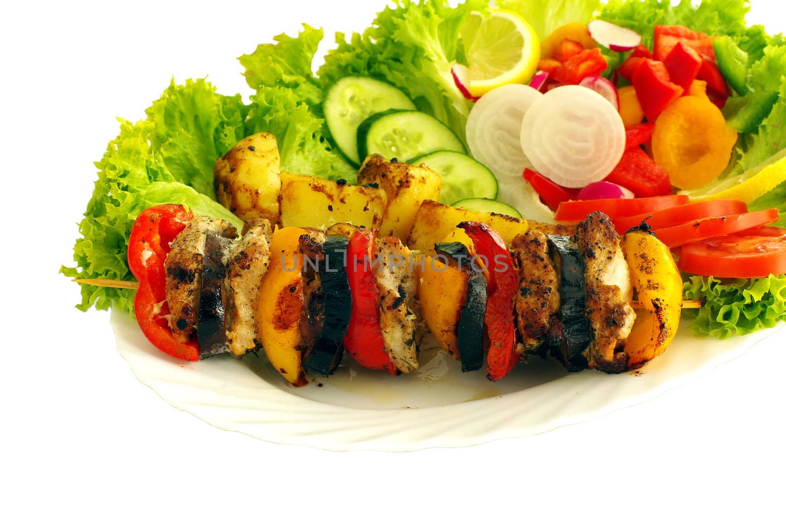 barbecue and vegetable on plate on white background