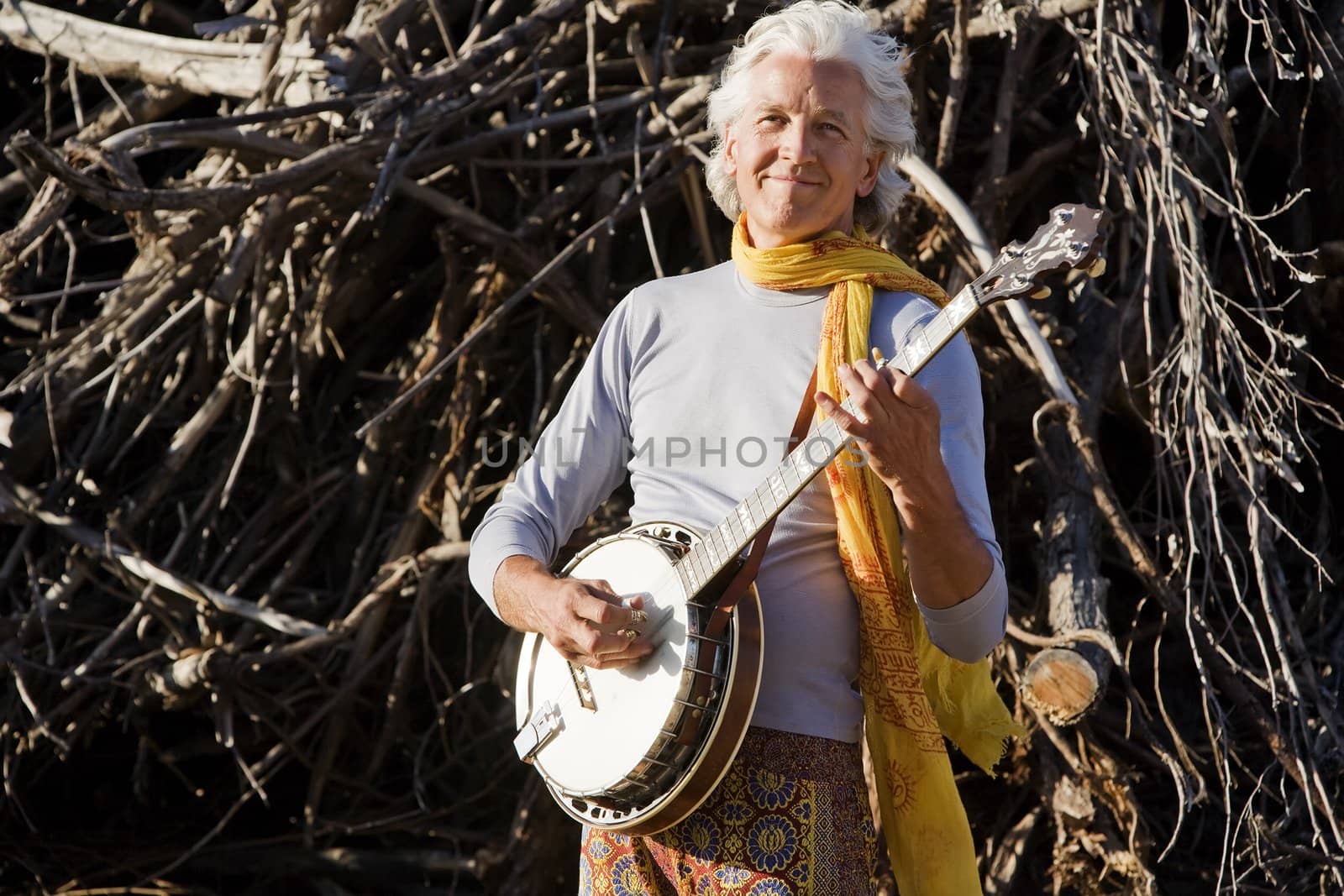 Banjo Player in Front of a Big Pile of Wood