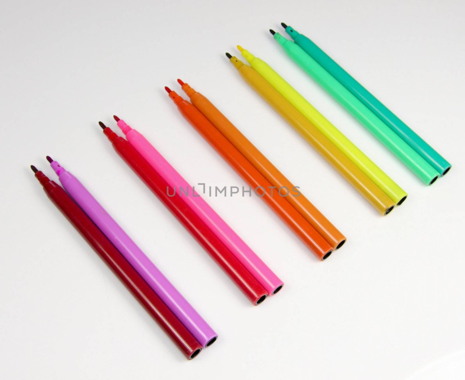 Coloured or colored felt tip pens in a colour spectrum isolated on a white background