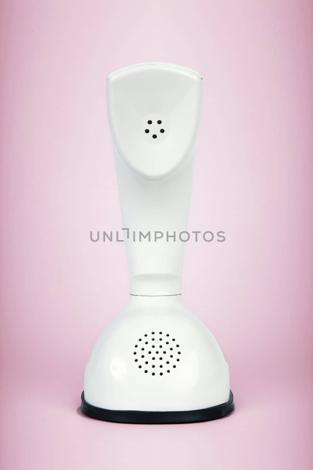 Stylish retro telephone from the sixties isolated on pink background