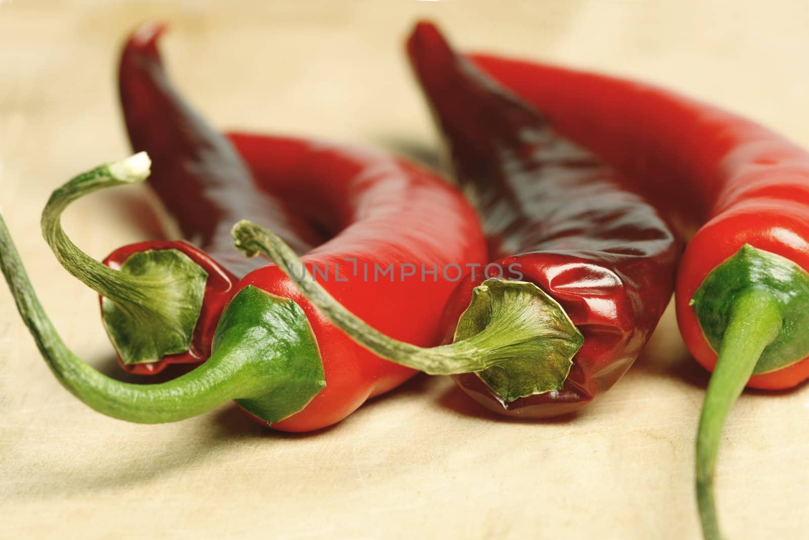 Macro shot of red hot chilli peppers on a cutting board