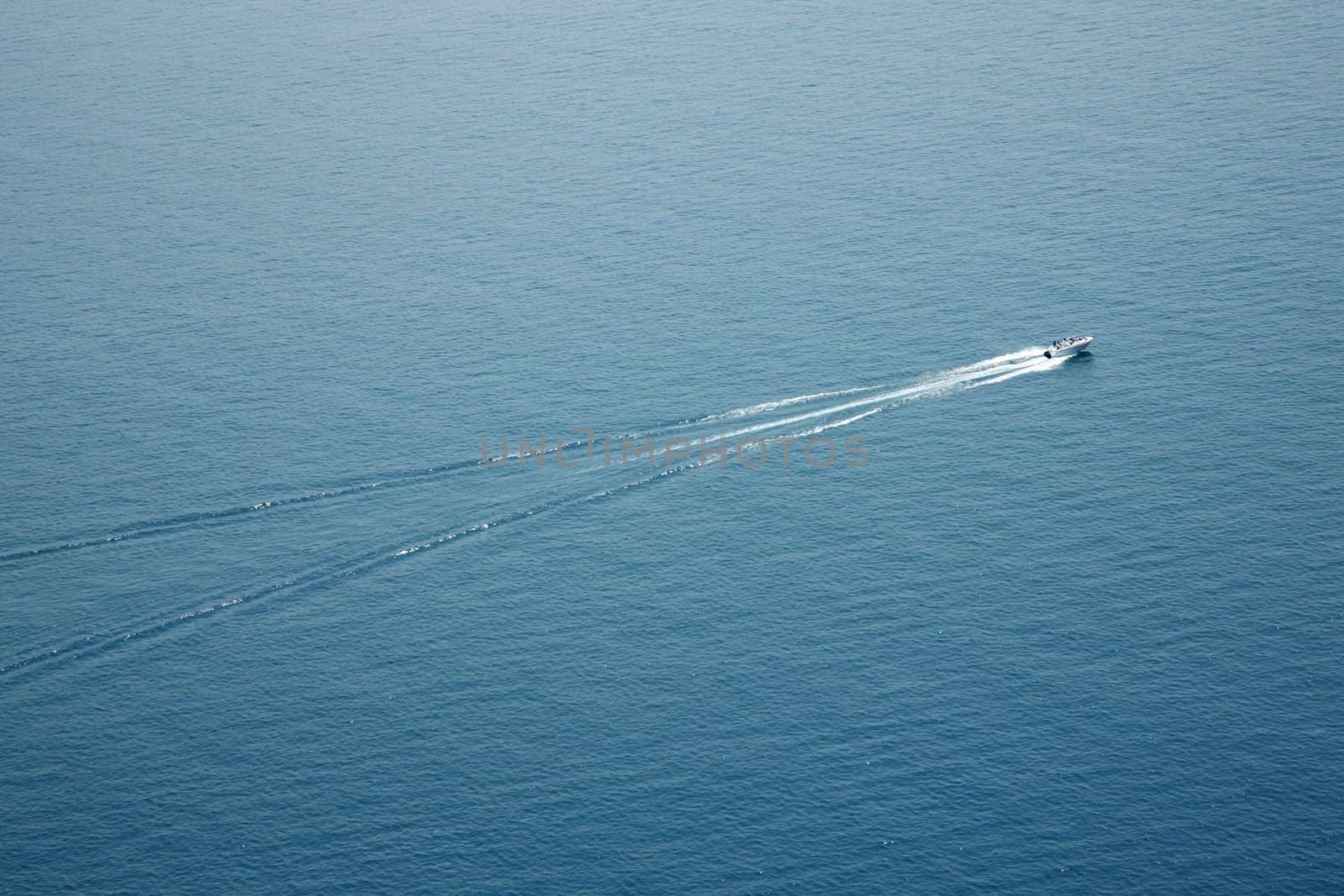Birds view of a speedboat traveling on a large body of water