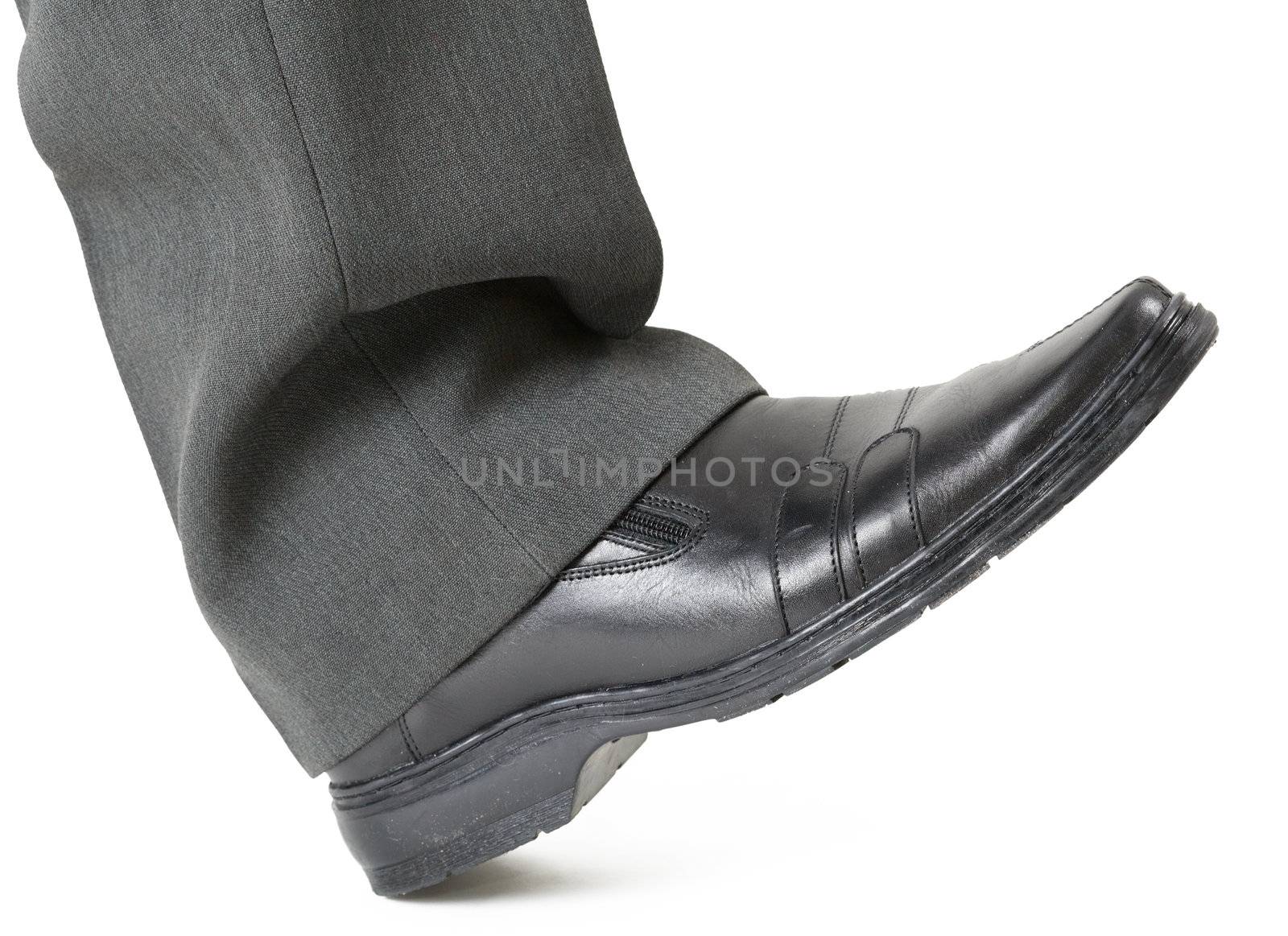Man's foot in a shoe is ready to crush