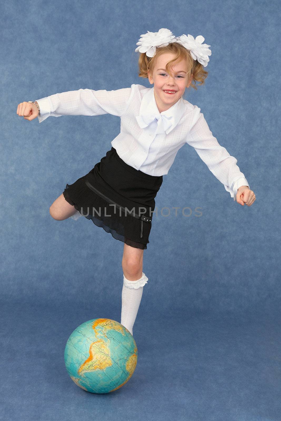 Schoolgirl kicks the globe as a footballer