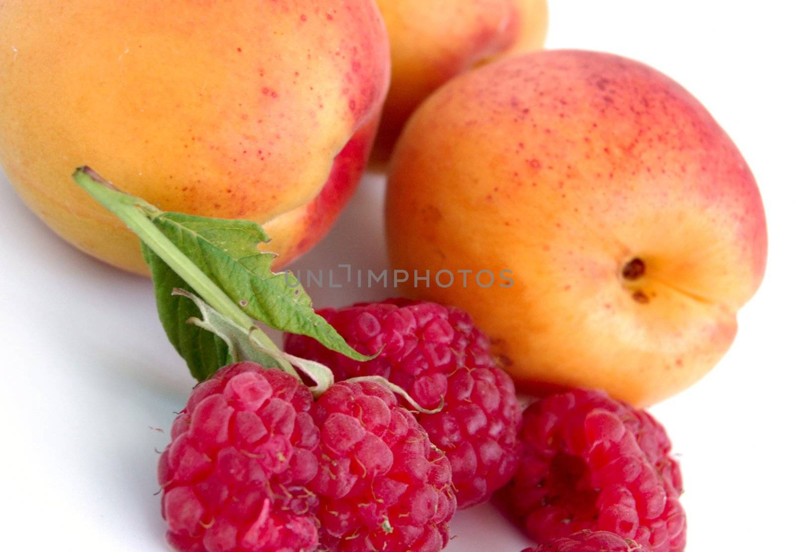 close-up of raspberry and apricots by mettus