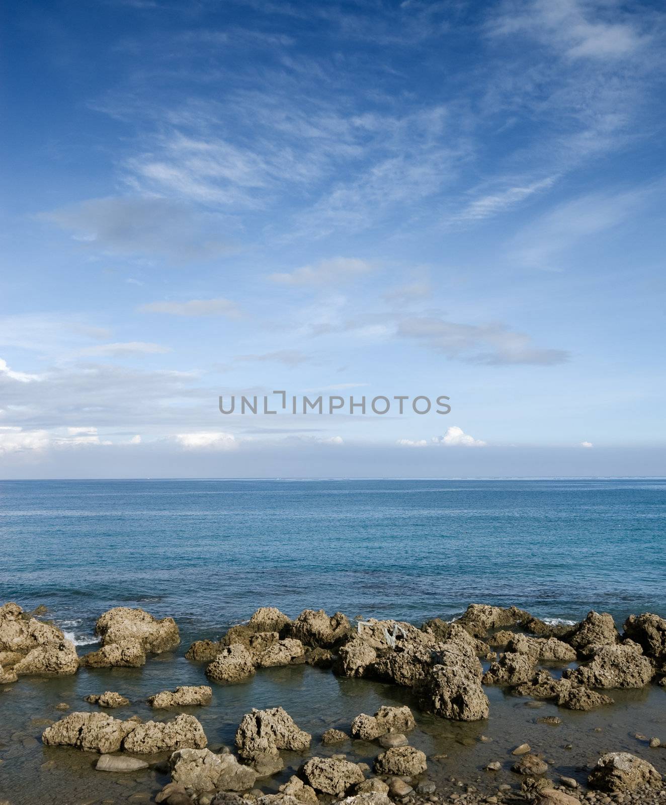 Coral reef rock coastline with blue sky.
