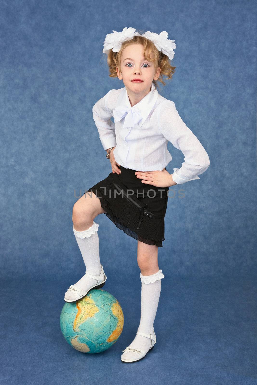 Schoolgirl set foot on a globe like a soccer ball