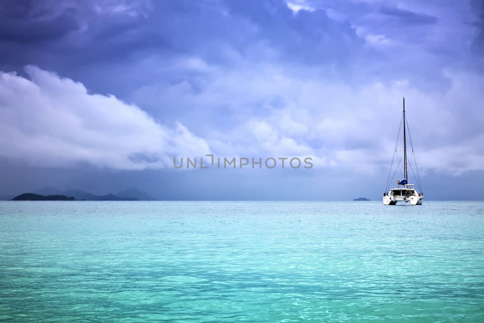 A photography of a catamaran in the ocean and overcast sky