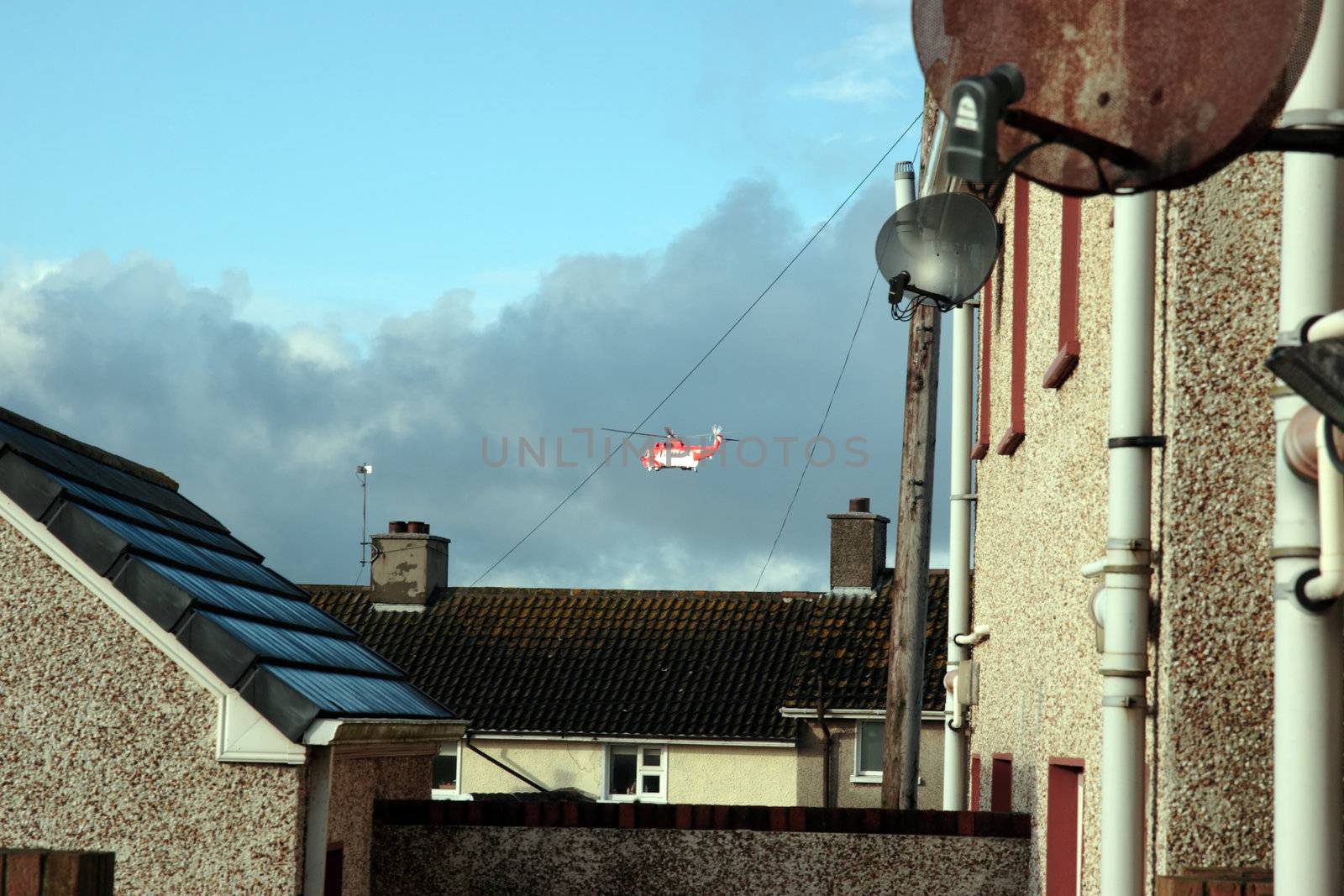 a helicopter on a life air sea rescue mission over an urban area in ireland