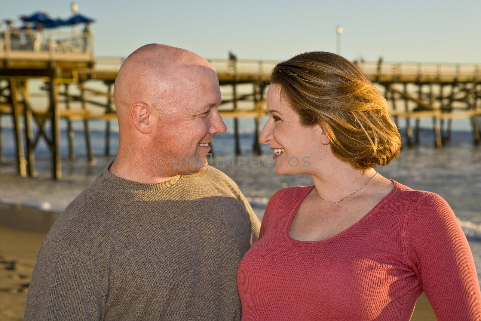 Couple in love at the beach looking into each others eyes