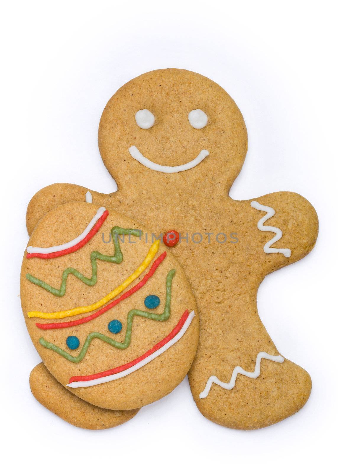 Smiling gingerbread man holding an easter egg cookie