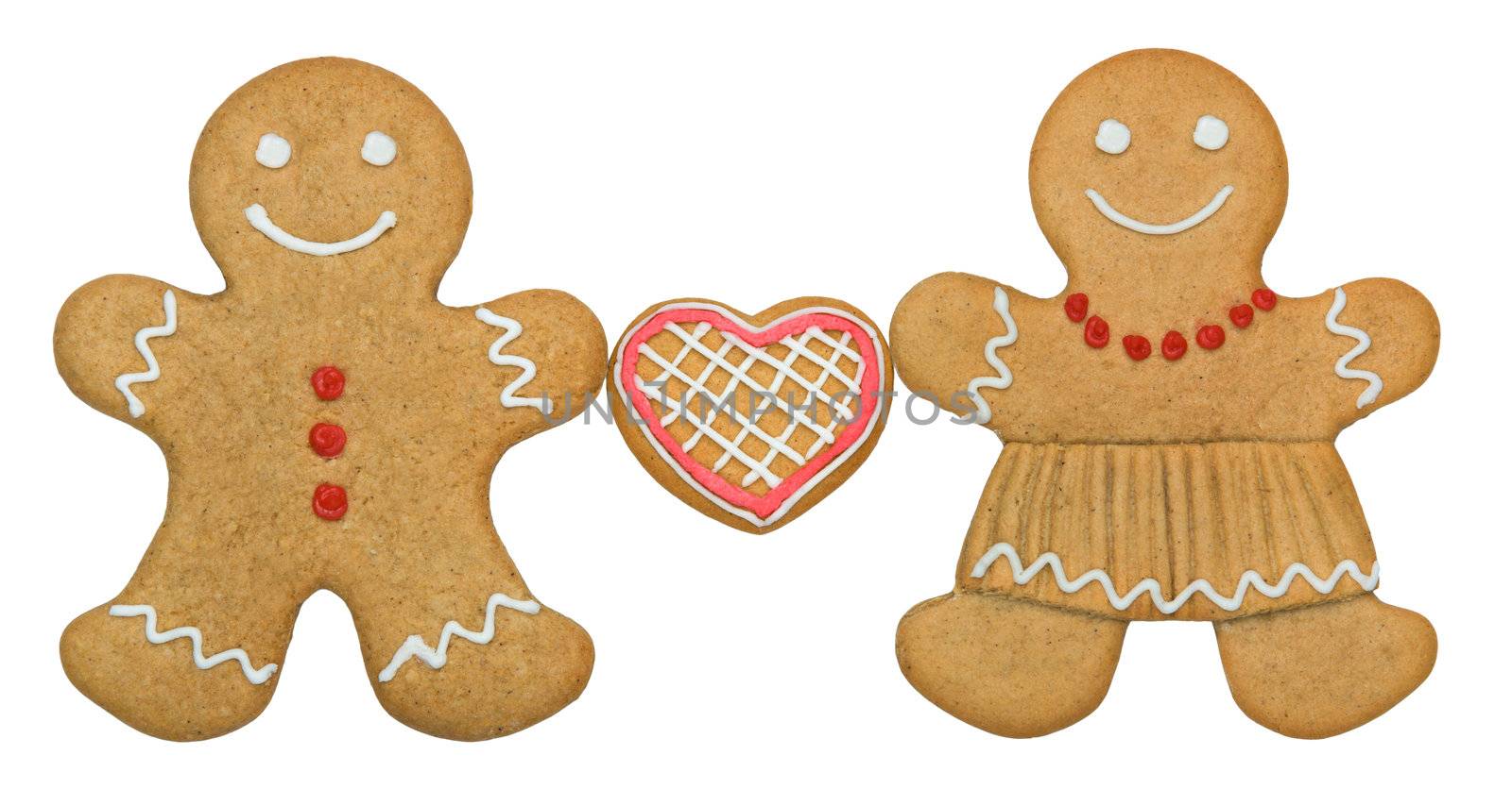 Gingerbread couple holding a heart shaped cookie