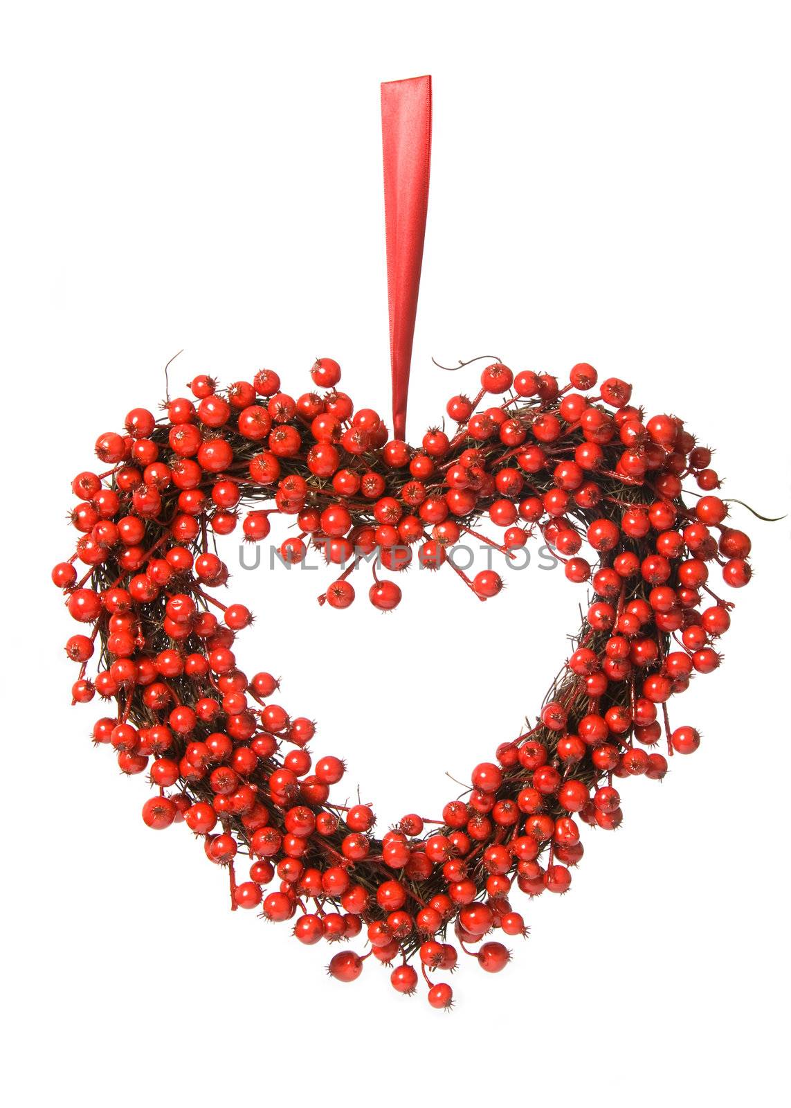 Heart-shaped red berry wreath against white