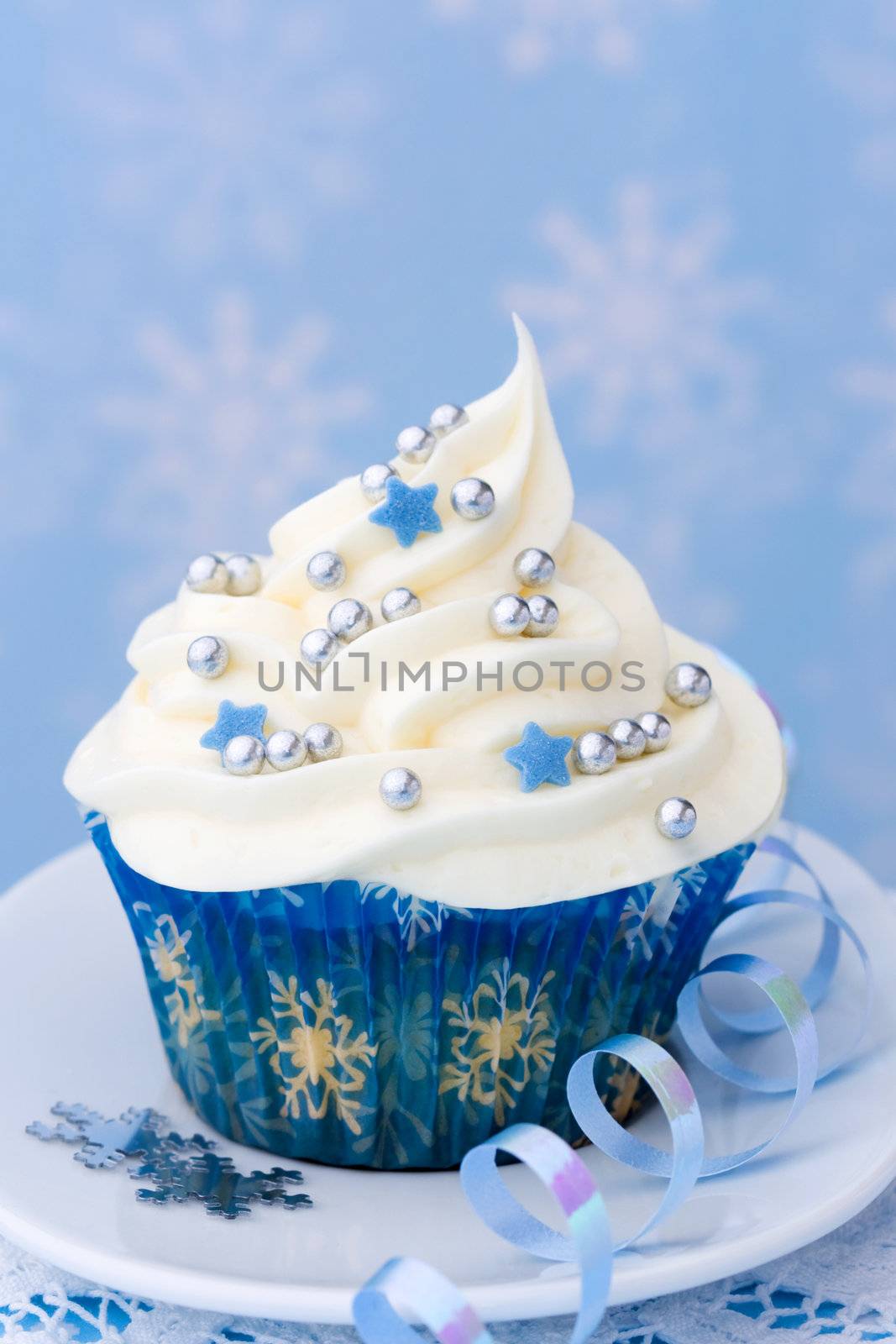 Cupcake with a winter theme against a snowflake background