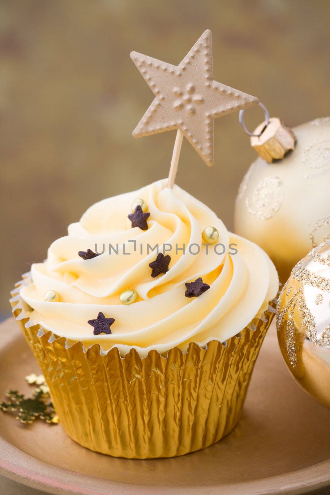 Golden cupcake with Christmas baubles
