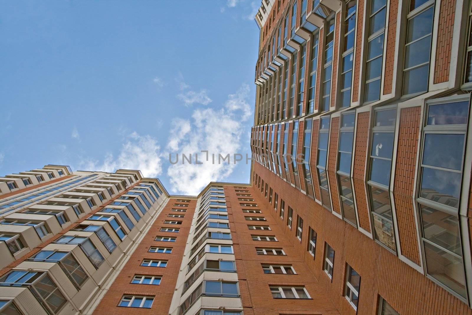 A residential multistory house and sky, view from below