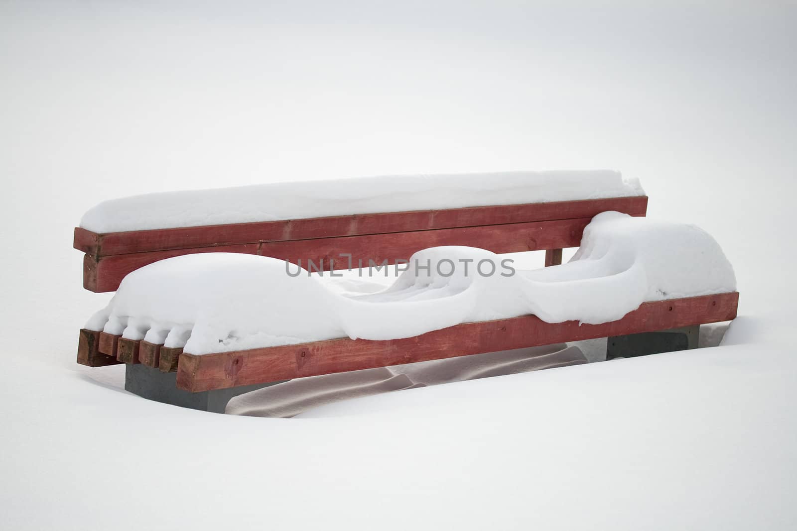 close-up lonely bench covering with white snow