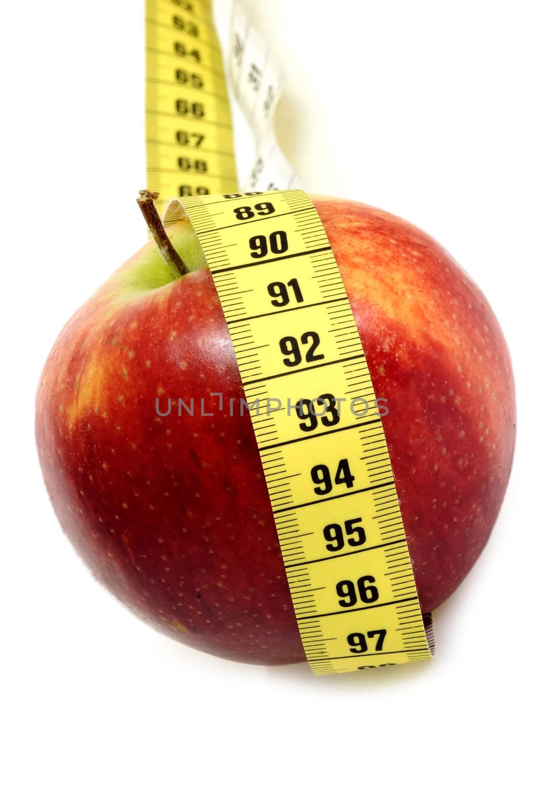 Red apple with tape measure on bright background