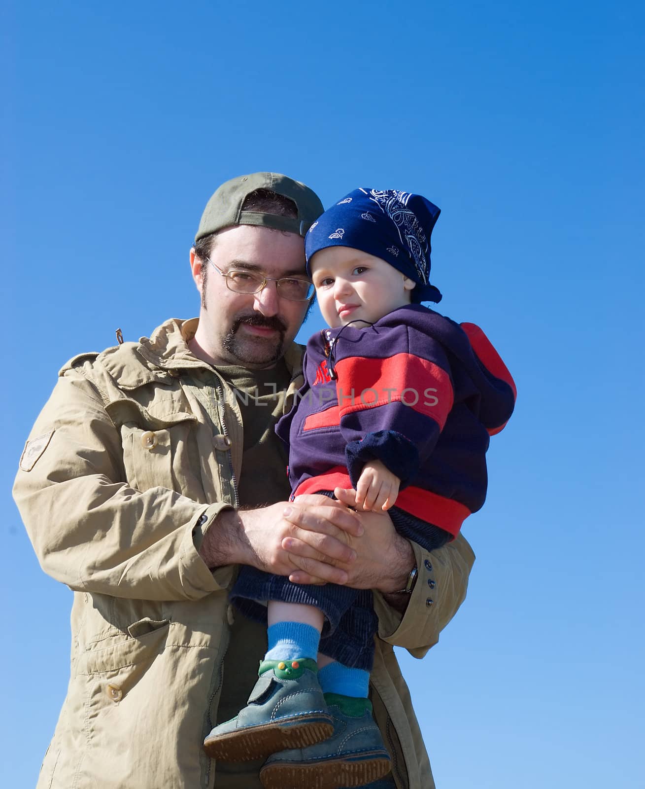 Family under blue sky.father and son