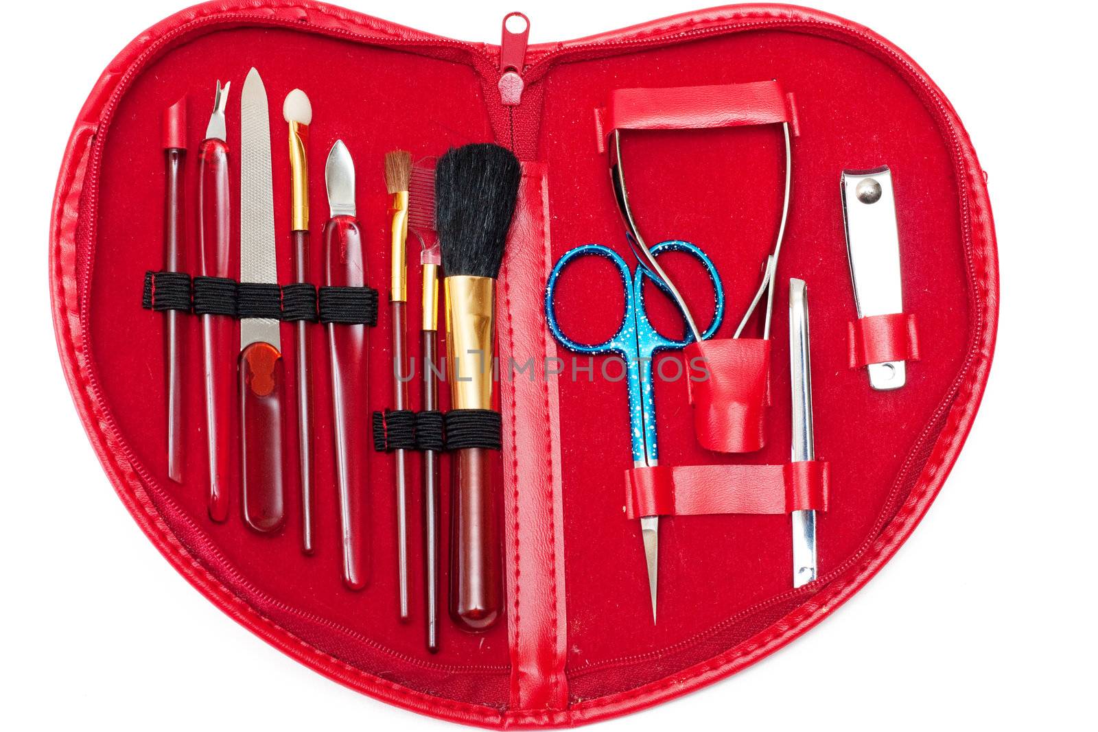 Manicure set in red heart-shaped bag over white background