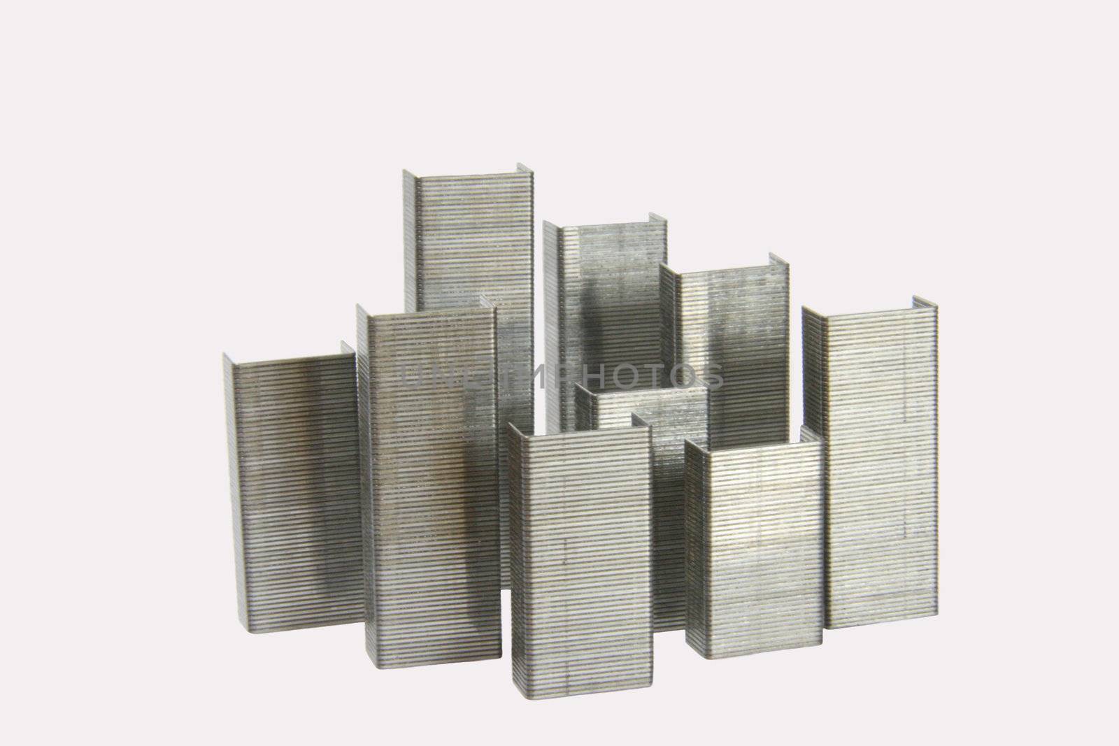 Staples office equipment isolated on a white background arranged in a city scape