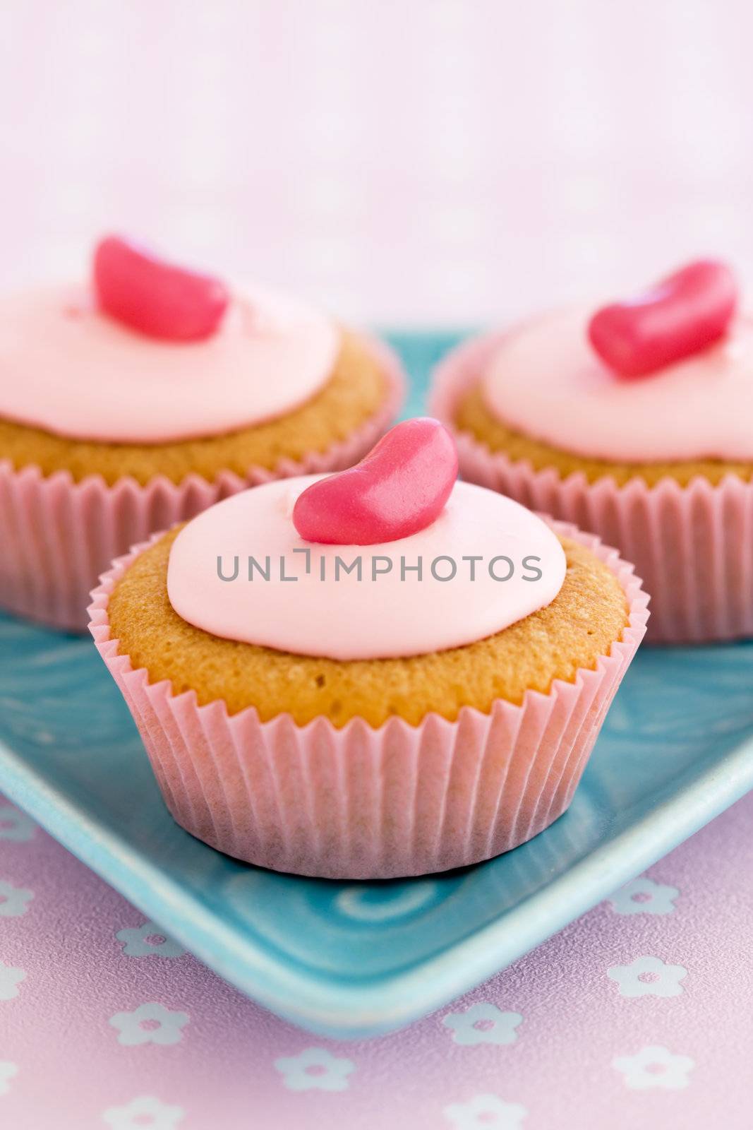 Trio of pink cupcakes decorated with jellybeans