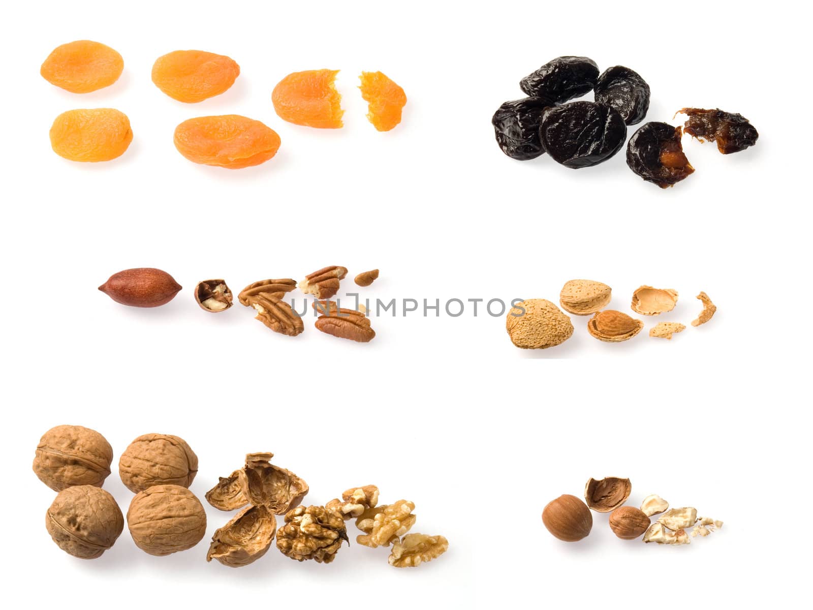 Collection of whole and opened dried fruits over white.