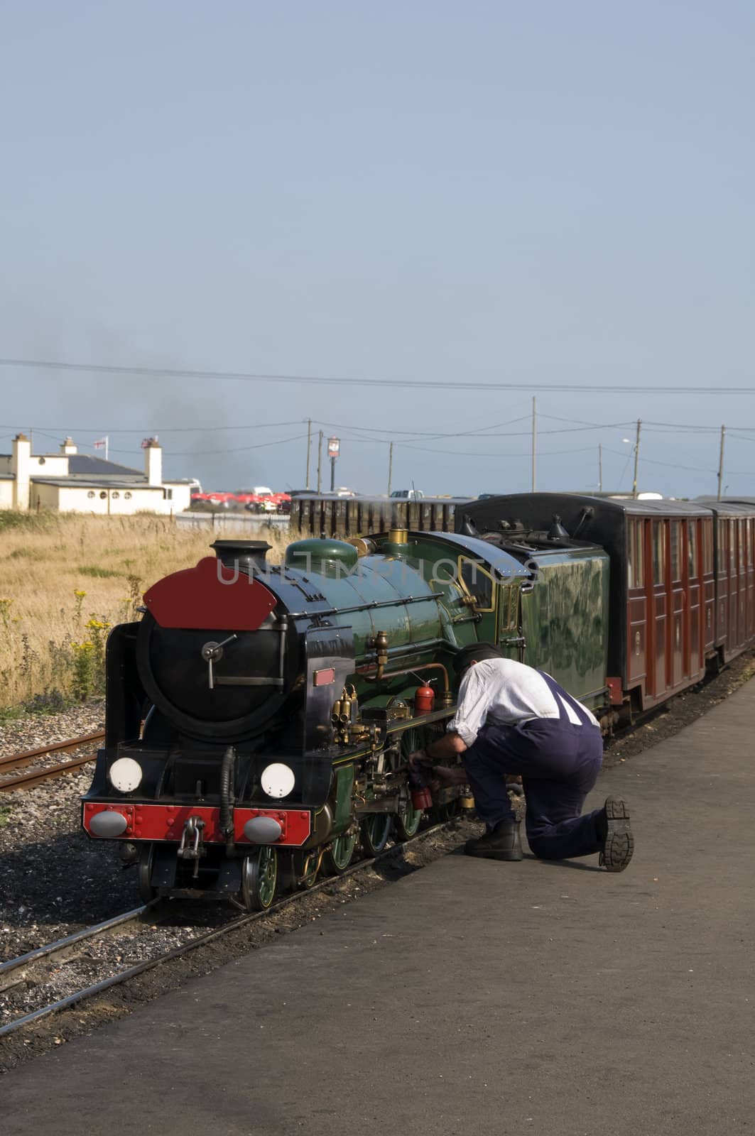 A man working on a miniature steam train