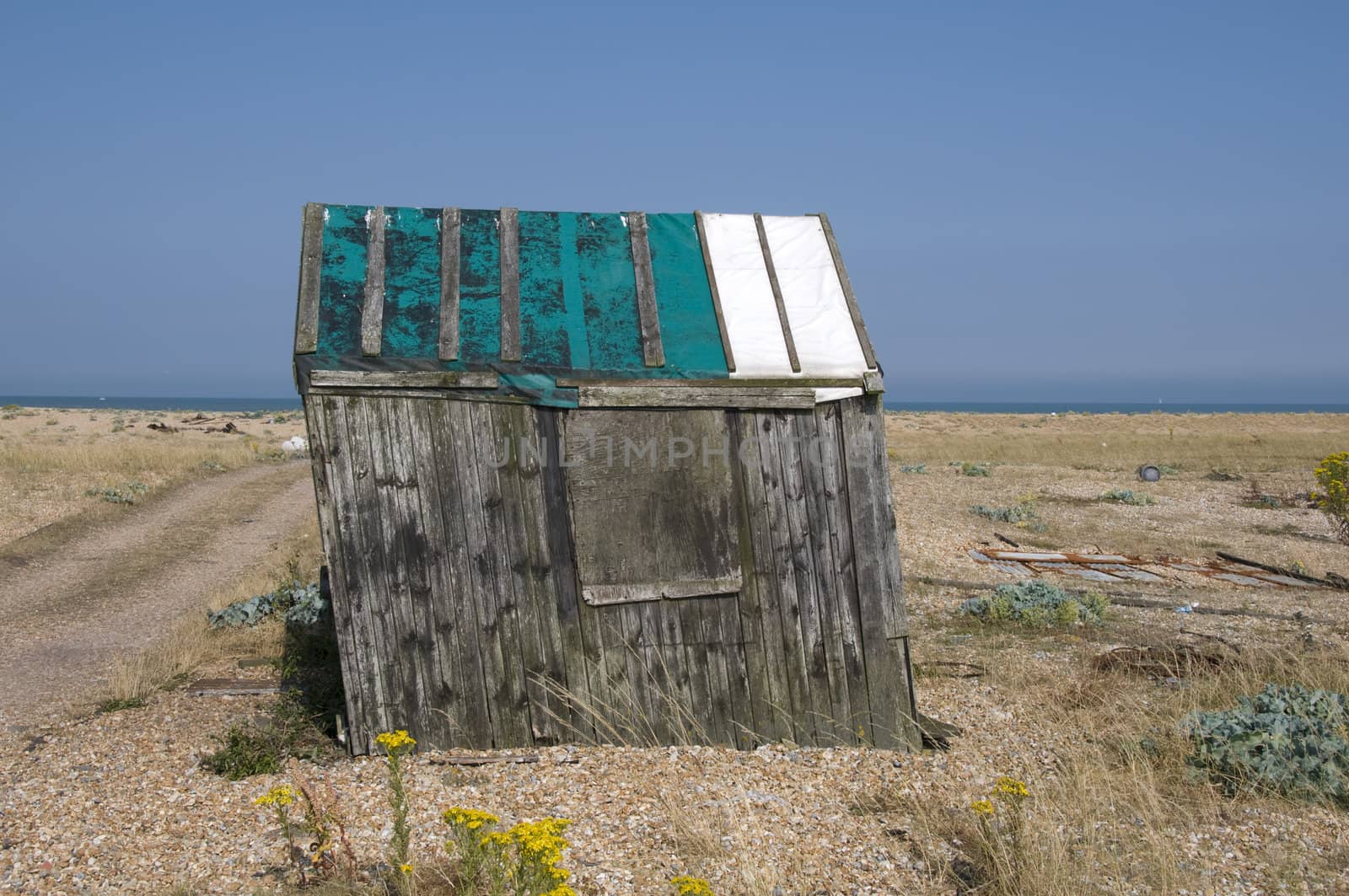 An old abandond fishing hut on a shingle beach