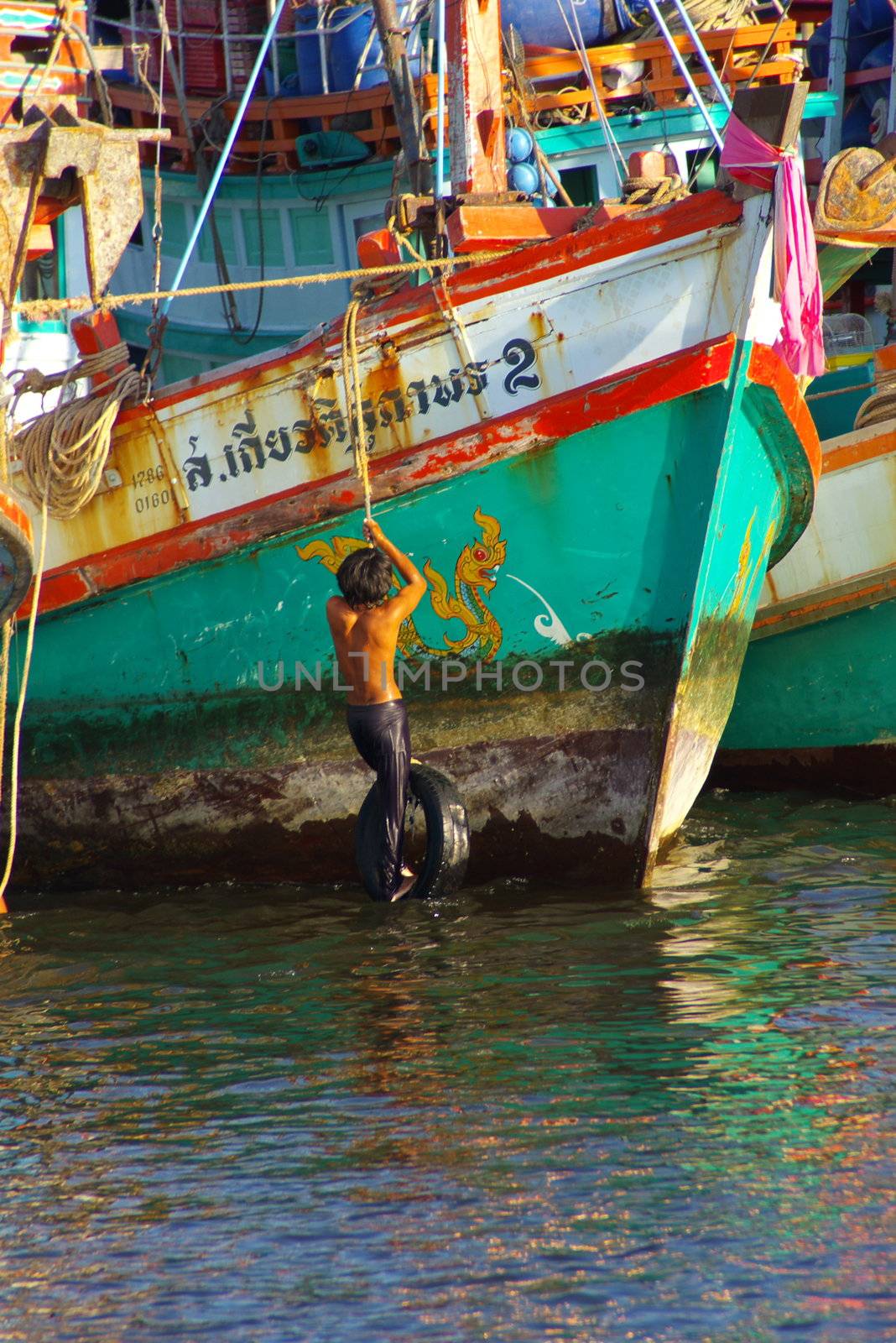 Asian man working on his fishing boat