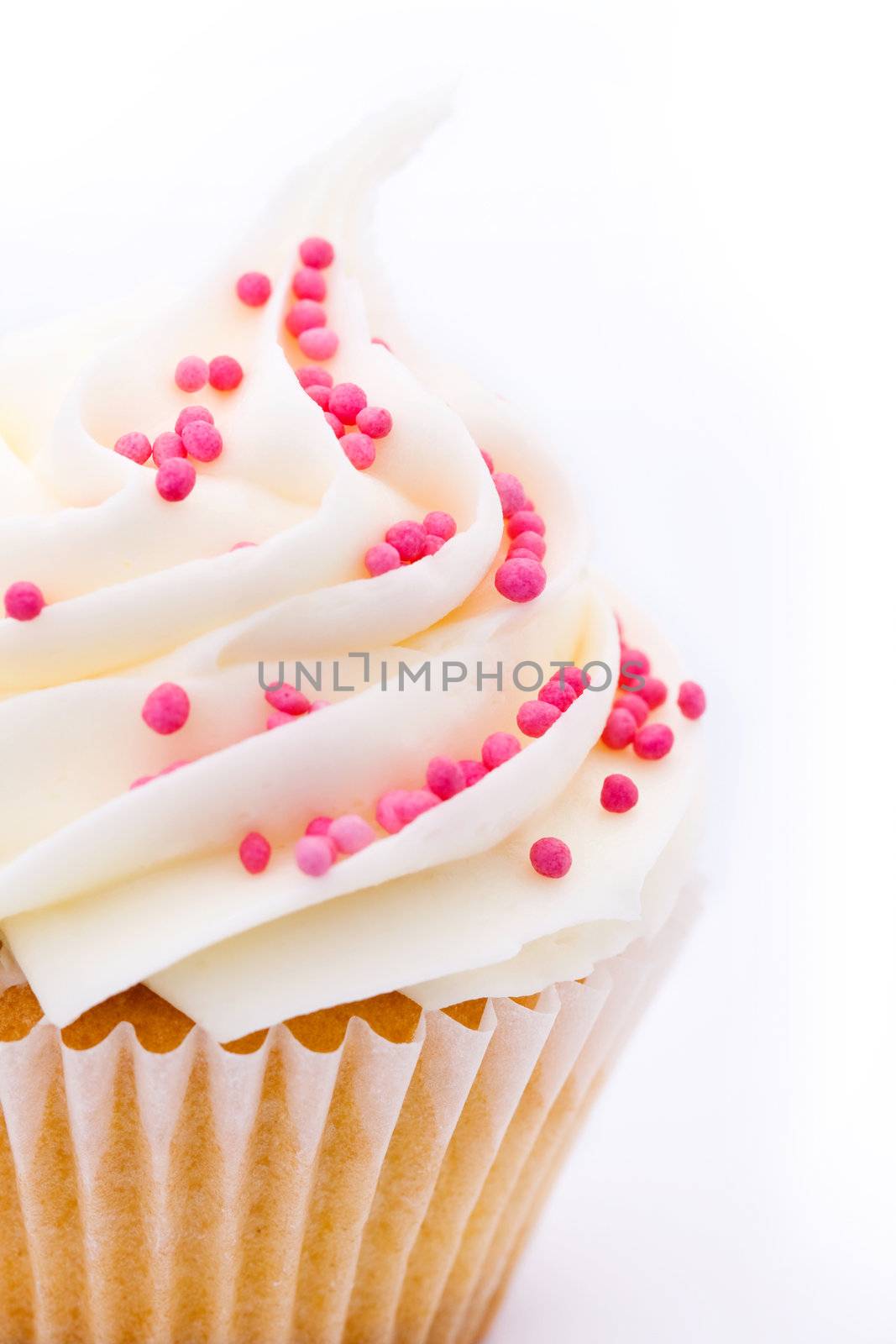 Closeup of a cupcake decorated with pink sugar sprinkles
