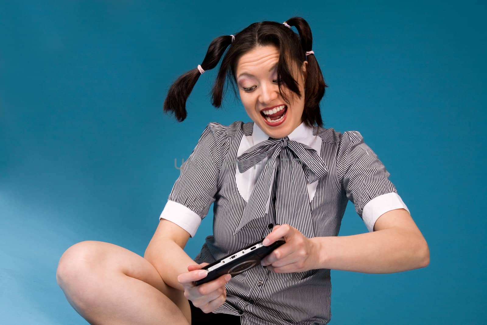 Young concentrated girl playing a game.