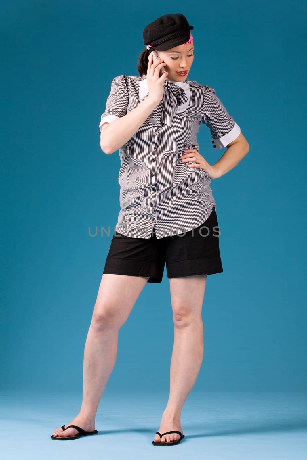 Young asian girl is calling and standing. Full body photogrphed