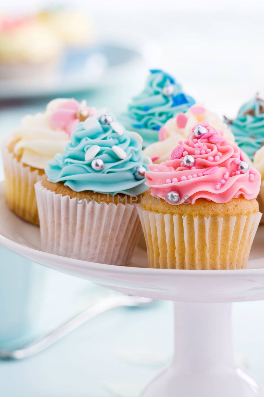 Assortment of colorful cupcakes on a cakestand