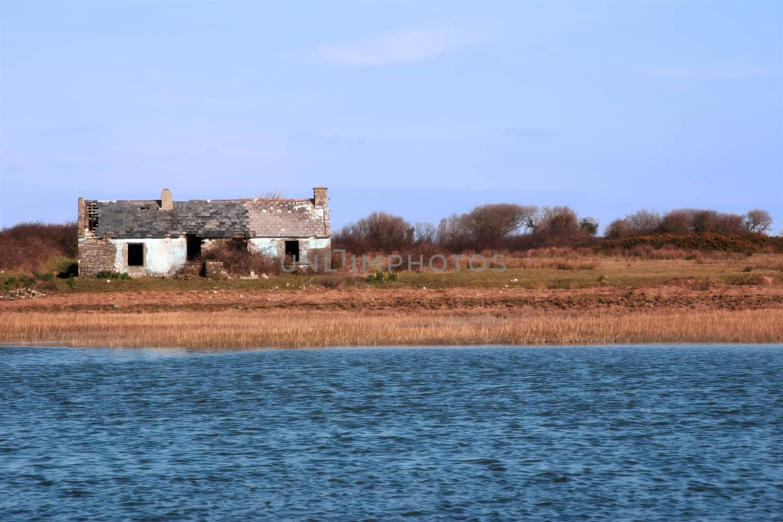 an isolated cottage in the irish country side beside a river