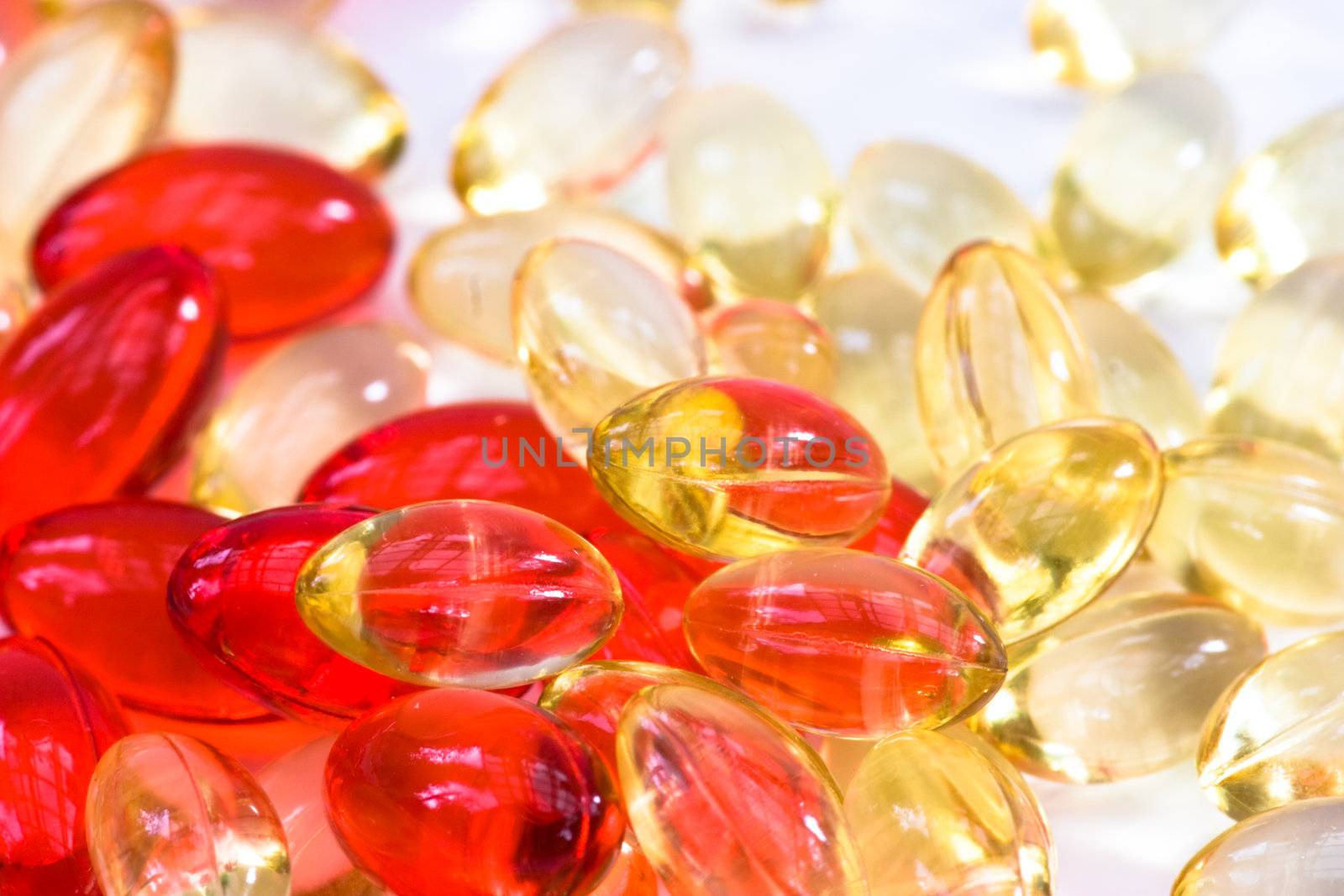 Yellow and red vitamin pills background