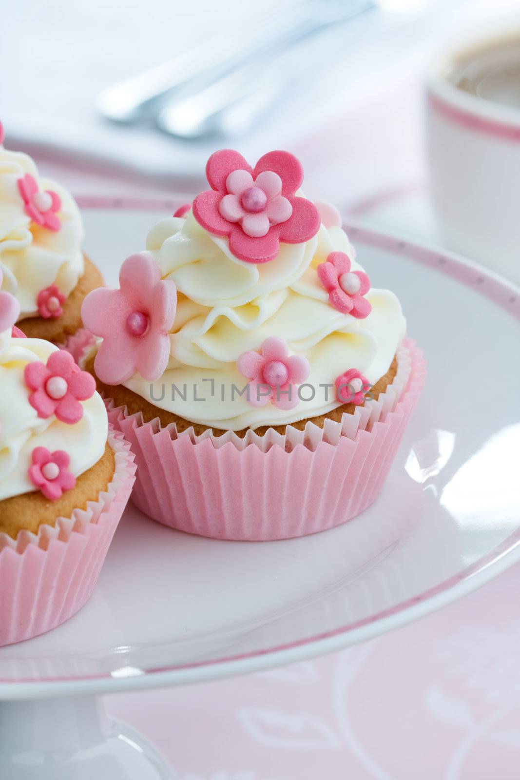 Cupcakes decorated with pink fondant flowers